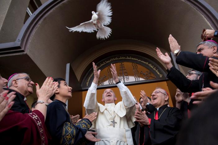 Pope Francis releases a dove at the end of a visit to the Chaldean Catholic Church of St. Simon Bar Sabbae in Tbilisi